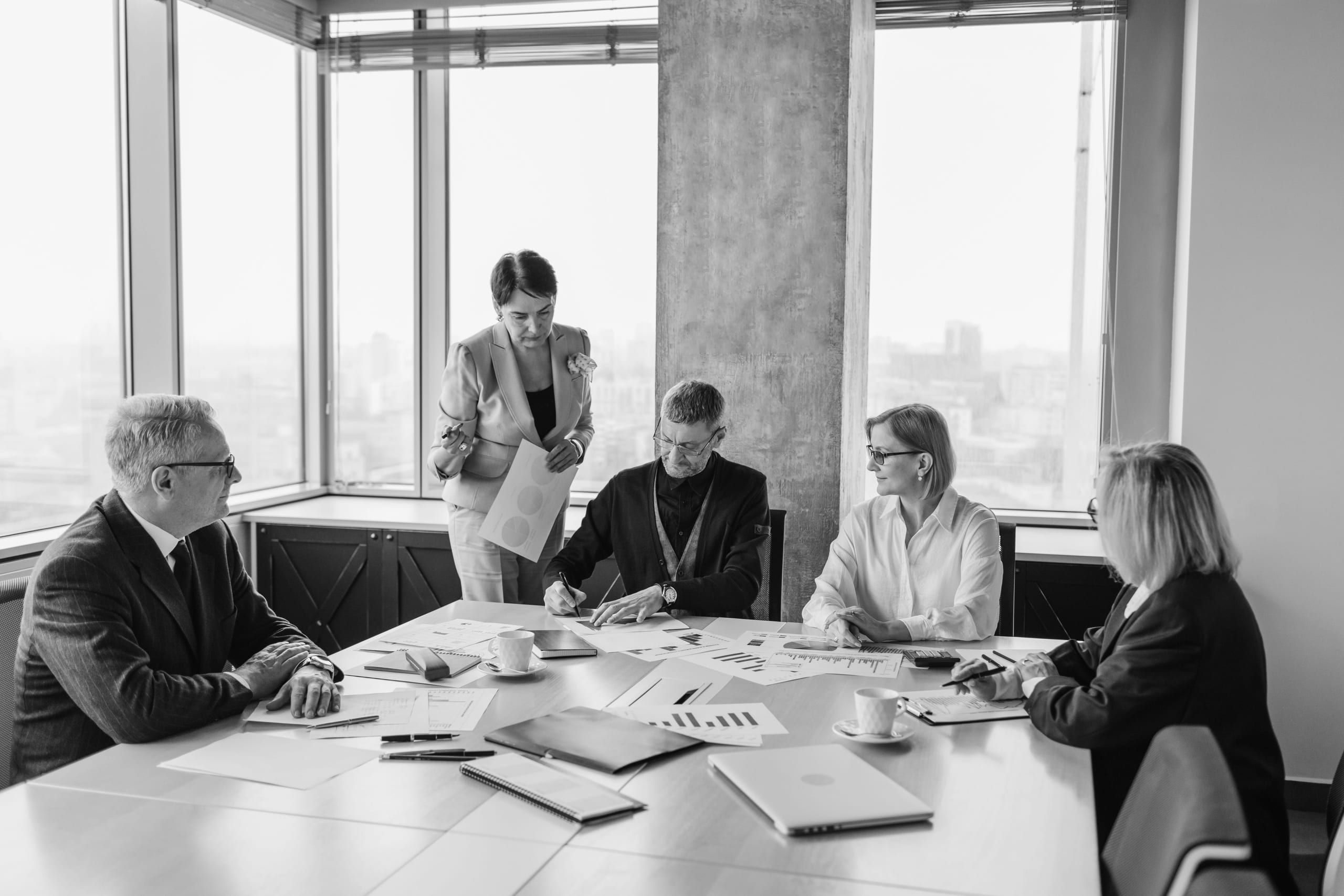 Consultants in a workshop around a table full of documents